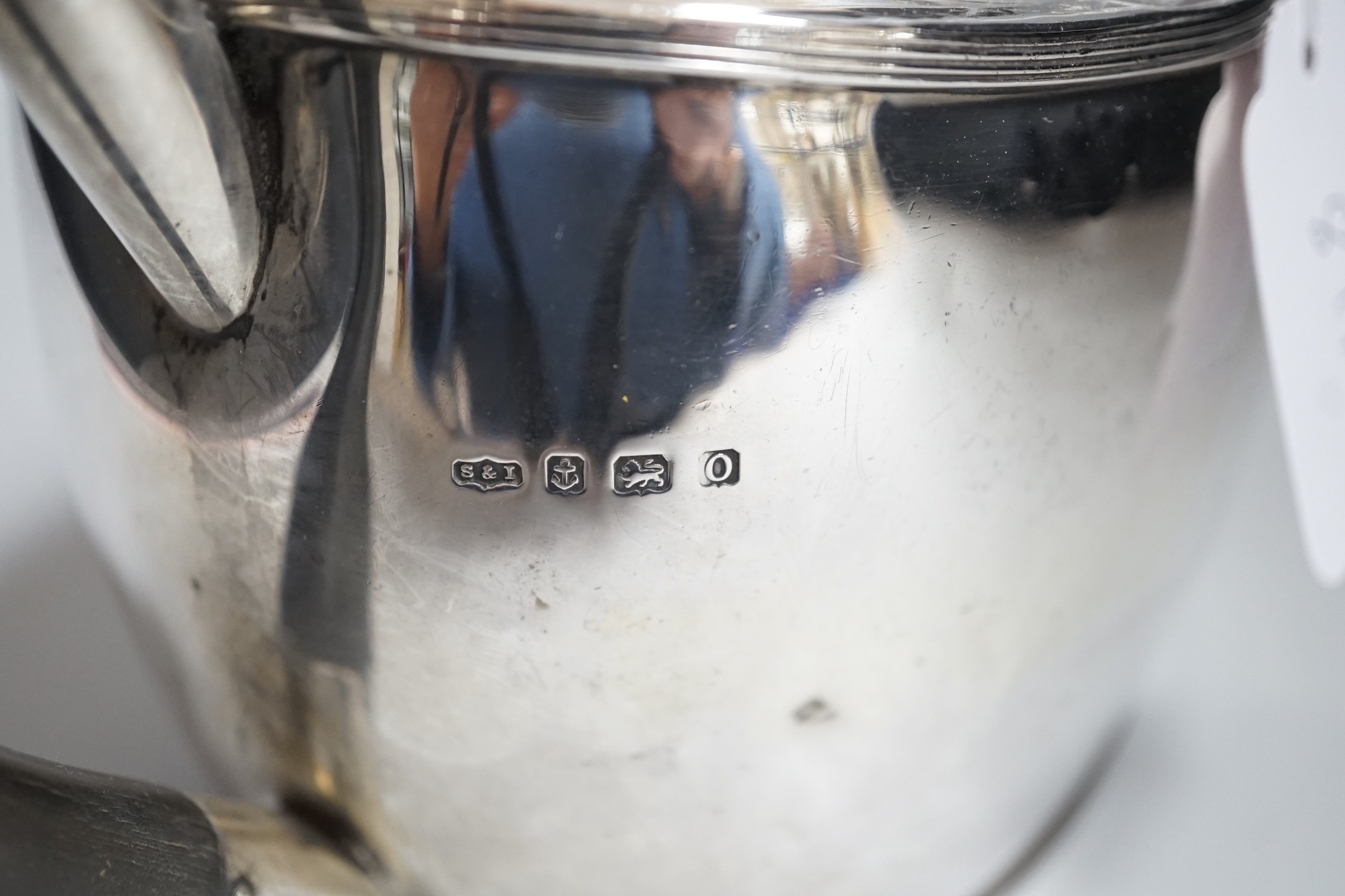 A George V silver oval teapot, Birmingham, 1913, three silver cigarette cases and a silver matchbox holder, gross weight 29oz.